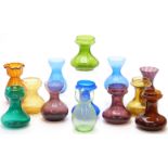 Thirteen coloured glass hyacinth vases all of squat form, largest 20.5cm tall.