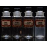 A set of four chemists/ pharmacy glass apothecary bottles with gilt labels including Bism Carb and