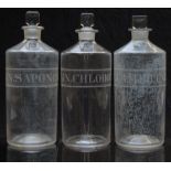 A set of three chemists/ pharmacy glass apothecary bottles with engraved labels including Lin