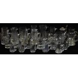 Twenty six various 19thC land later clear glass tankards, some with engraved descoration, largest
