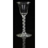 An 18thC clear drinking glass with opaque double twist stem and waisted bowl raised on conical foot,
