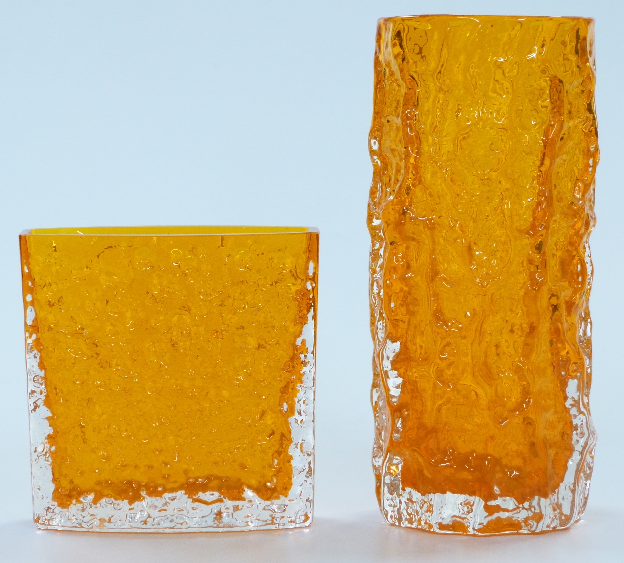 Two Geoffry Baxter Whitefriars textured bark glass vases in tangerine, largest 19cm tall