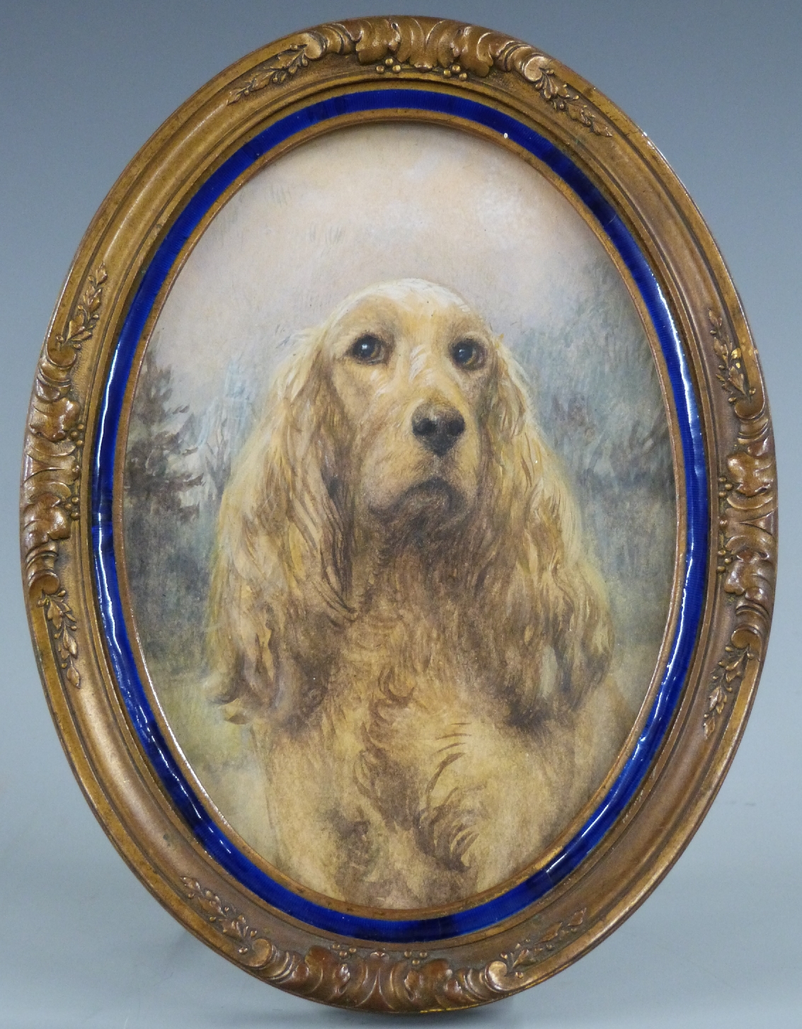 A 19thC watercolour miniature of a Cocker Spaniel in enamel and gilt frame, overall H16cm