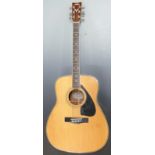 Yamaha FG-440 acoustic guitar fitted with six steel strings and decorative mother of pearl insets to