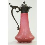 Cranberry glass water jug with wrythen molded body and silver plated mounts, 29cm tall.