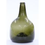 An 18thC green glass onion wine bottle, 23cm tall.