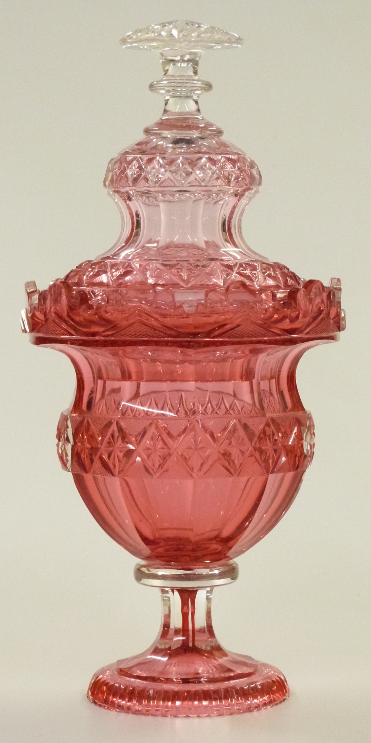 Bohemian cranberry glass comport and cover with deep cut decoration, raised on pedestal base, 32cm