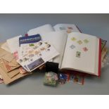 Two stamp albums and a collection of loose stamps