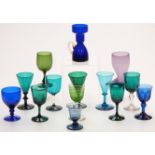Fourteen coloured glass drinking glasses inclusing amethyst, Bristol blue etc, one in the form of