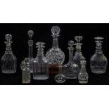 Ten various cut glass decanters including one on a wooden stand and three miniature examples,