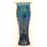 Loetz Papillon style glass vase with feathered decoration over mottled blue ground, 21.5cm tall.