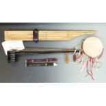 A collection of various instruments to include an Asian Erhu, Oriental bamboo pipes, descant