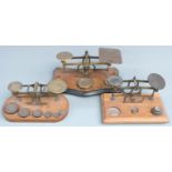 Three sets of Victorian brass postage scales, one with Avery weights, width of largest 25cm