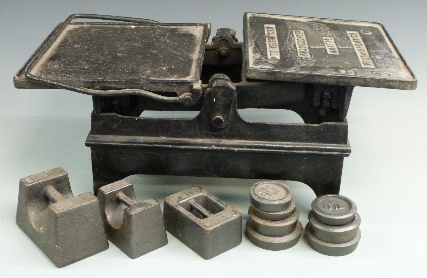 J & J Siddons Ltd 1cwt scales, width 65cm and ten assorted weights including William Cross and Son