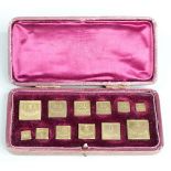 Leather cased 19thC or early 20thC set of apothecary weights from 120 grains downwards