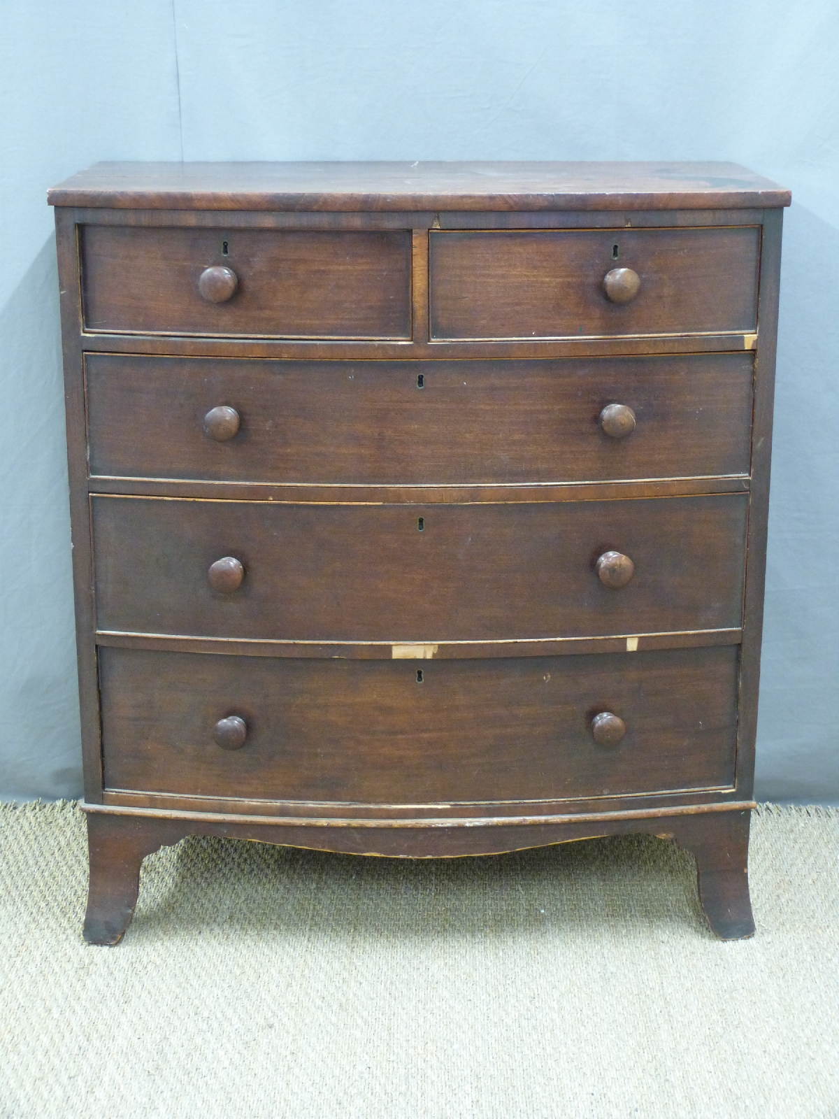 A late Georgian / early Victorian mahogany bow fronted chest of two over three drawers, with