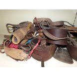 A large collection of equestrian items including riding hats, one Charles Owen size 7 3/8, leather