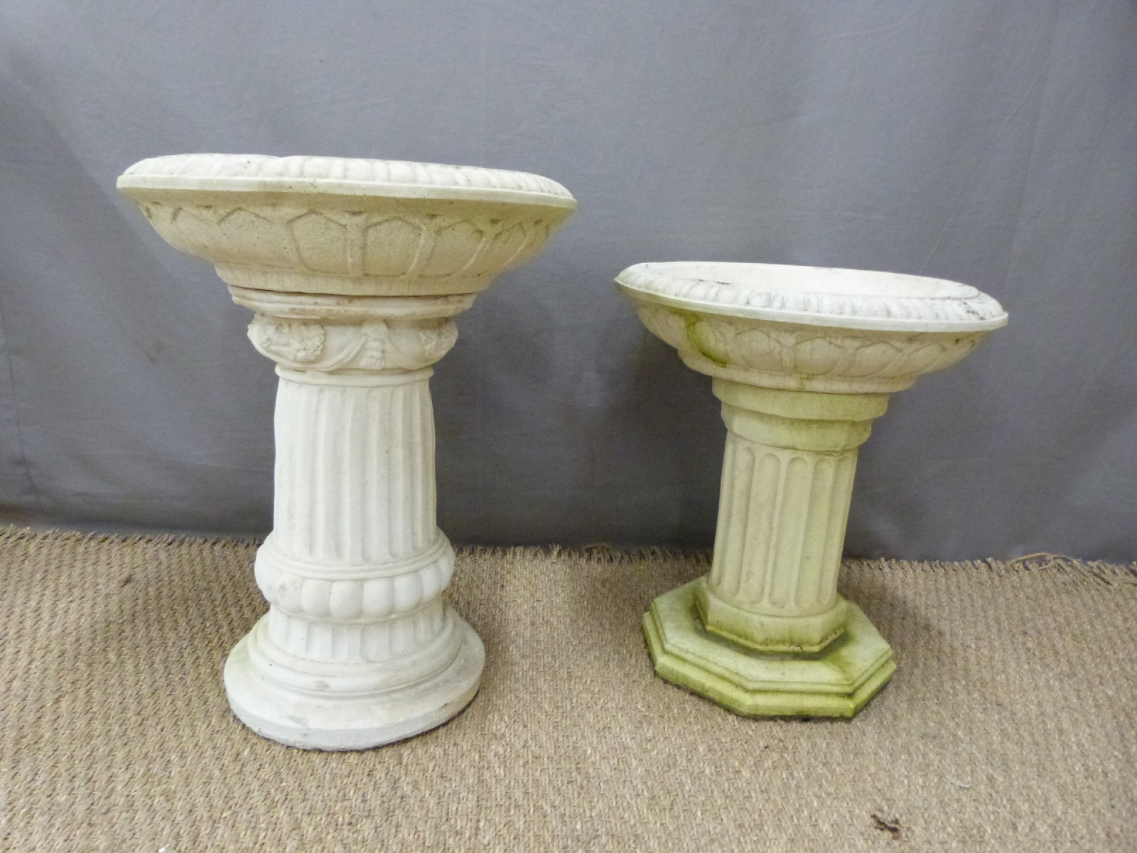 Two small bird baths raised on reeded columns, height of taller 53cm