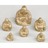 A run of six brass weights formed as Buddhas