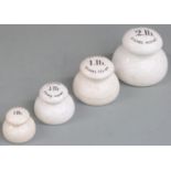 A run of four ceramic bun weights from 2lb to 1/4lb, the largest three marked Imperial Enamel