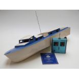 A wooden remote control model boat with MacGregor Digimac II transmitter and control manual, 90cm