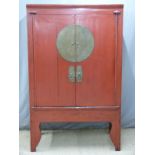 Chinese red lacquer cupboard with brass mounts, the interior with two drawers, shelves and secret