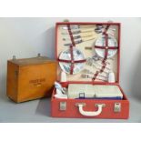 Brexton England picnic set in red rexine case, 1950's, together with a wooden first aid box