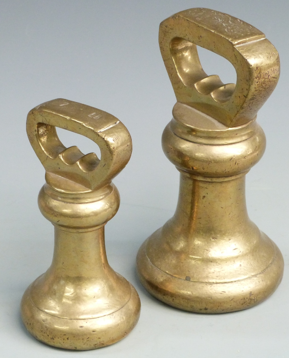 Two Georgian / Victorian brass bell weights comprising 14lb and 7lb stamped with GR cipher to base