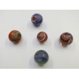 Five very large handmade glass marbles one with pink, blue and white central core surrounded by