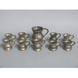 A quantity of pewter measures or tankards