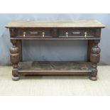 Carved oak sideboard having two drawers, supported on bulbous carved legs united by a shelf, W137