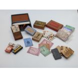 A collection of vintage games and playing card accessories including whist markers, card boxes,