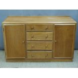 Ercol style Arts & Crafts light elm or similar sideboard having four drawers flanked by cupboards,