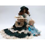 Three bisque collectors' dolls two by Cindy McClure and one other similar, largest 50cm tall on