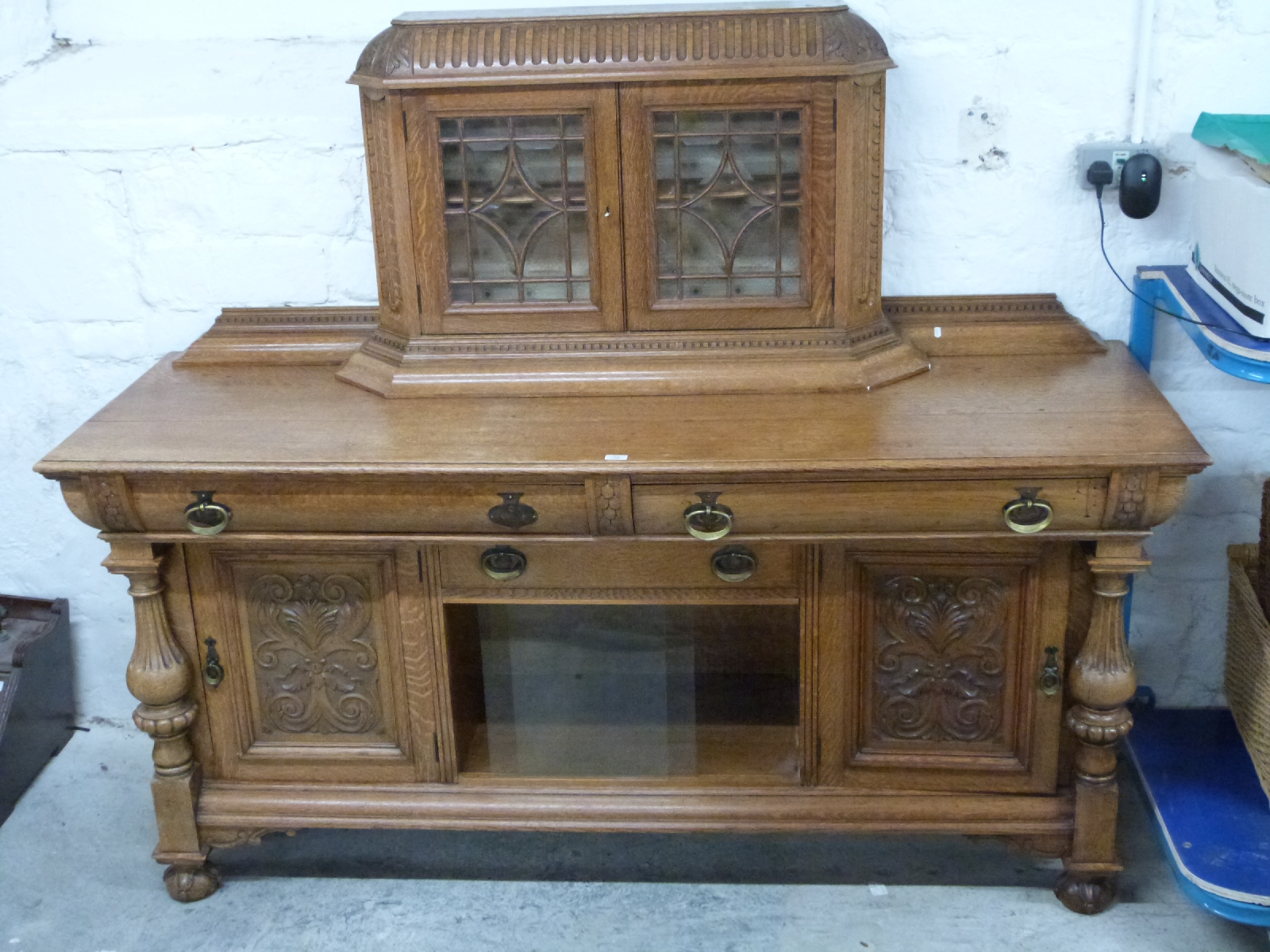 Art Nouveau oak sideboard with bevelled astragal glazed cabinet to top, the base fitted three