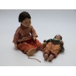 Two lacquer dolls, one Japanese with painted features and silk outfit (40cm tall) the other Indian