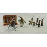 Nine Britains diecast model soldiers comprising six Gurkhas and three Queen's Guards on original