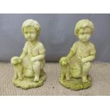 A pair of garden figures of boys with dogs, height 46cm