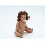 Heubach Koppelsdorf bisque headed doll with open mouth, weighted brown eyes, long brown hair and