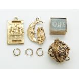 A 9ct gold passport charm/ pendant, a 9ct gold compass charm/ pendant, a 9ct gold moon and owl