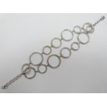 An 18ct white gold bracelet of modernistic circles set with diamonds, 25g