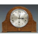 An oak cased mantel clock by Garrard, Westminster chimes, 23cm tall