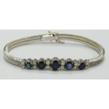 An 18ct white gold bracelet set with five graduated oval sapphires measuring approximately 0.65, 0.