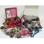 A collection of costume jewellery including large beaded necklaces, etc