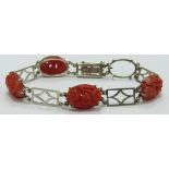 A 9ct white gold bracelet set with carved coral
