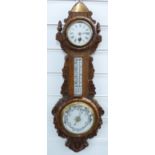 Edwardian oak framed carved aneroid barometer/clock and thermometer compendium, 63cm tall