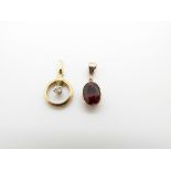 A 9ct gold pendant set with an oval garnet and a 9ct gold pendant set with a diamond, 2g