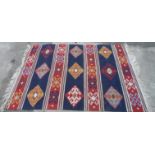 Hand woven rug with geometric pattern, 245 x 175cm