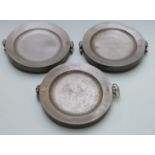 Three pewter plate warmers, each with London touch marks and marked E.W, width 28.5cm