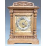 Oak cased c1900 shelf/bracket clock, the brass Arabic dial with silvered chapter ring, armorial